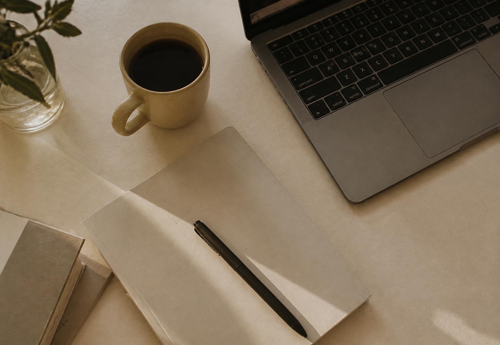 Bureau minimaliste avec carnet, stylo et ordinateur portable
